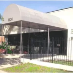 a white building with a black fence